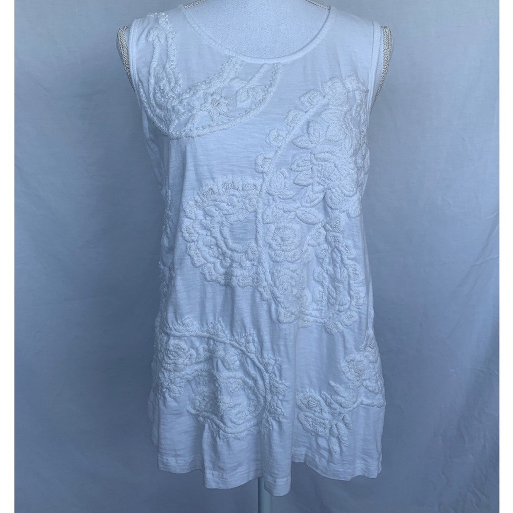 White on white embroidered sleeveless top.